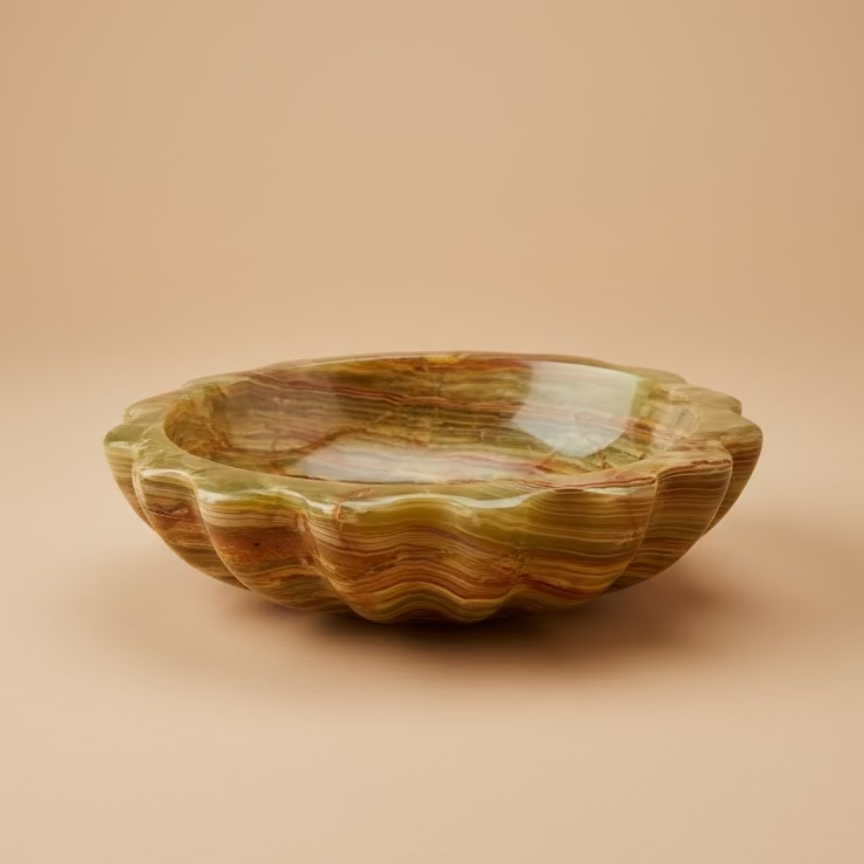 Decorative onyx bowl on a wooden table with a blurred background